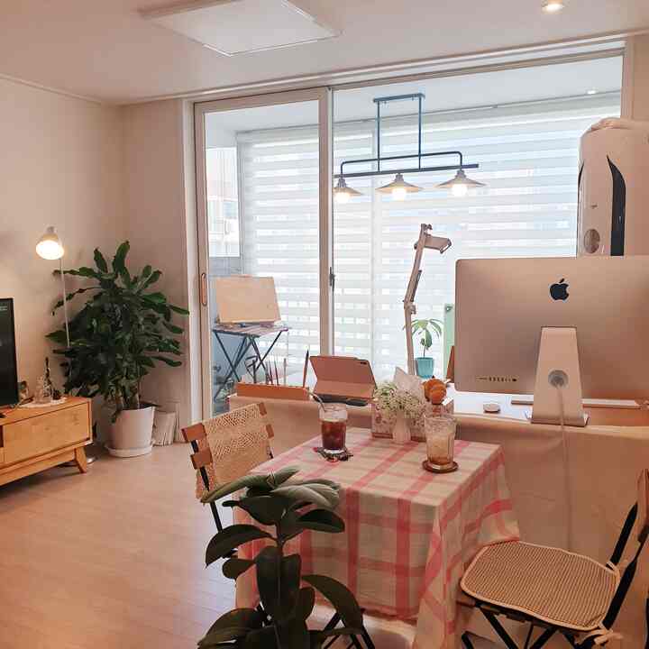 Natural color and wood tone living room featuring lighting and work devices in a warm, lovely multifunctional space