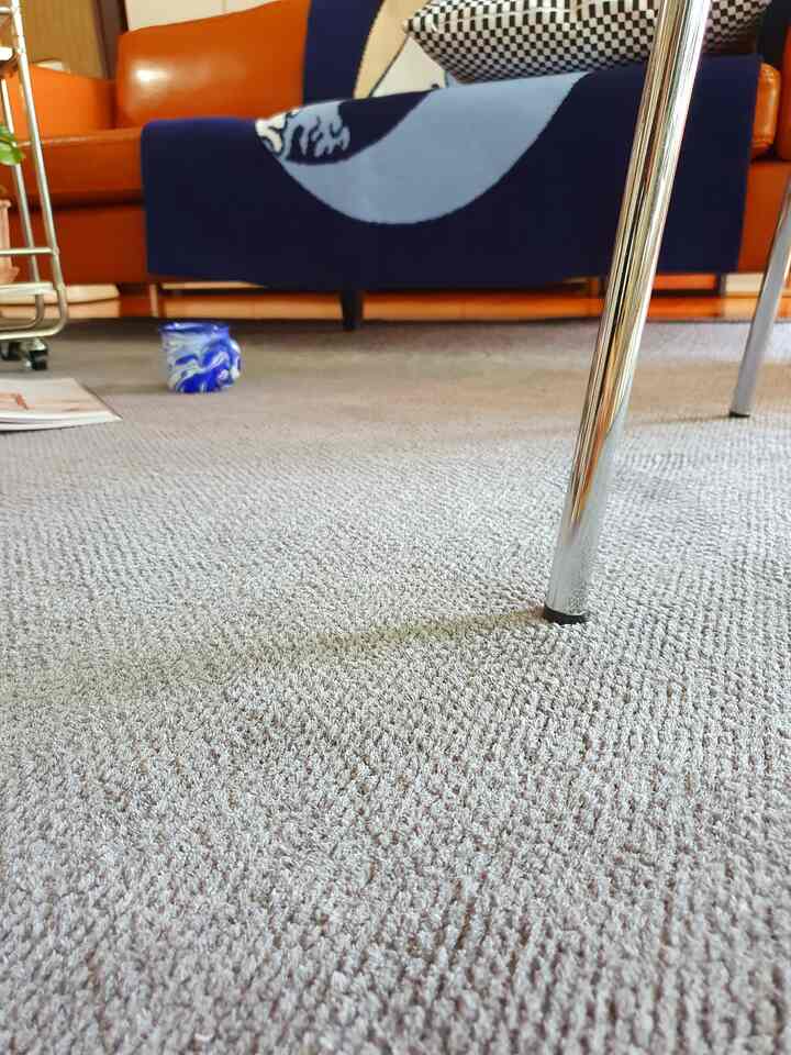 Brown and navy toned living room featuring leather sofas and a textured rug creating a cozy atmosphere