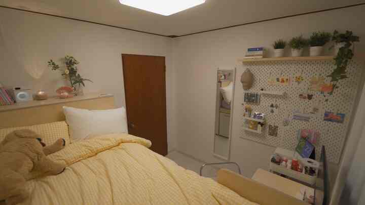Natural-toned small bedroom featuring bright yellow bedding and natural wood furniture with cozy atmosphere