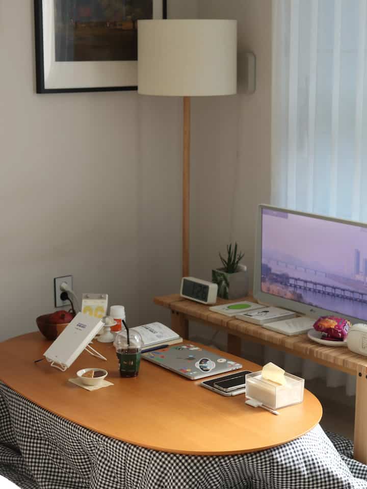 Cozy home cafe and reading space with beige walls and wooden oval table