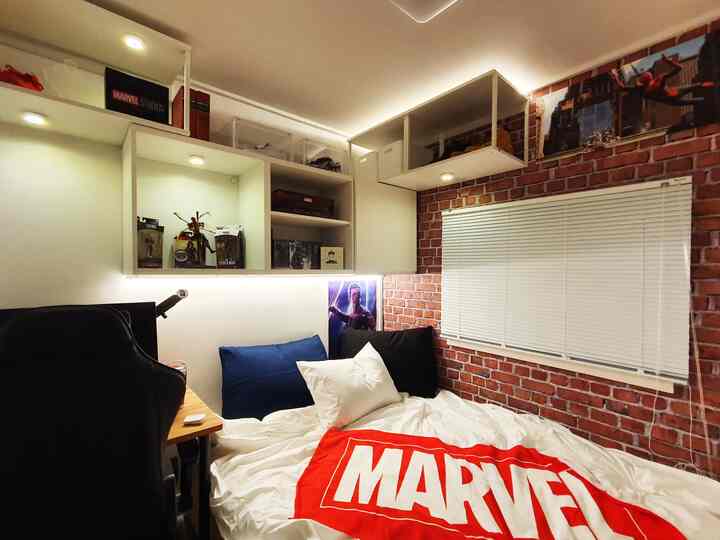 White and vintage red toned small single room featuring shelves and Marvel Spider-Man themed elements with cozy atmosphere
