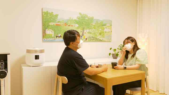 White walls and wood tone extendable dining table in a two-person dining room with a warm and cozy atmosphere