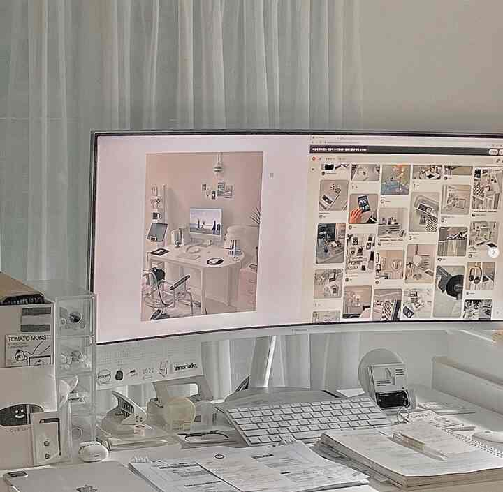 Monotone white, gray, and black compact home office desk area with tidy, modern atmosphere