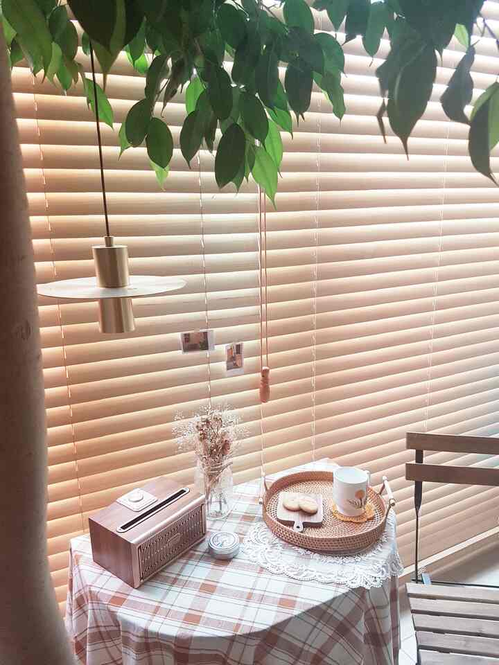 Natural-toned balcony featuring a rattan tray and plaid tablecloth creating a cozy atmosphere