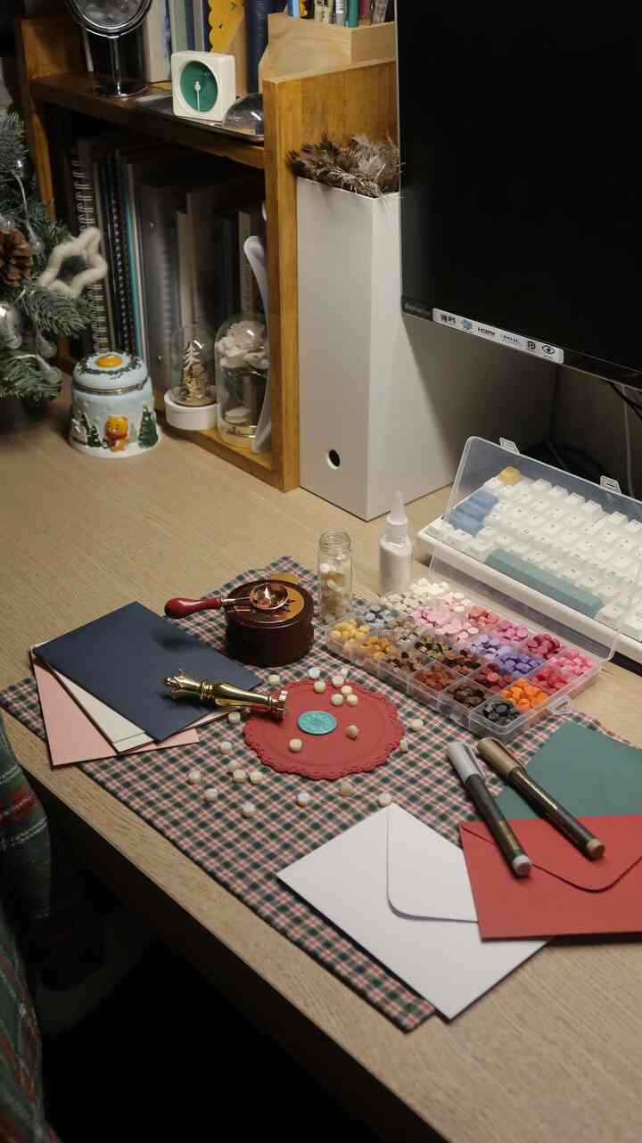 Wood tone and white harmonized desk workspace featuring sealing wax tools and organized items with a cozy, clean atmosphere