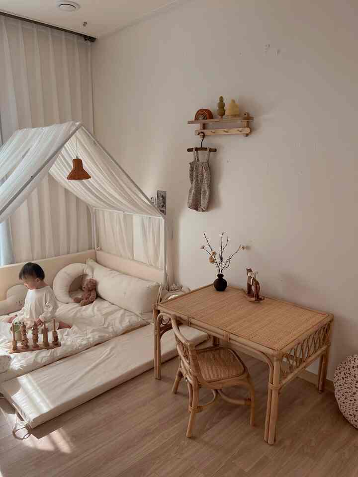 Natural color kids' room featuring rattan furniture and beige mattress with a warm, cozy atmosphere