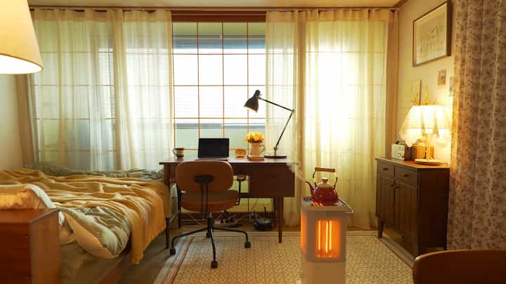 Warm beige tone compact bedroom featuring desk, standing lamps, and cozy home office atmosphere