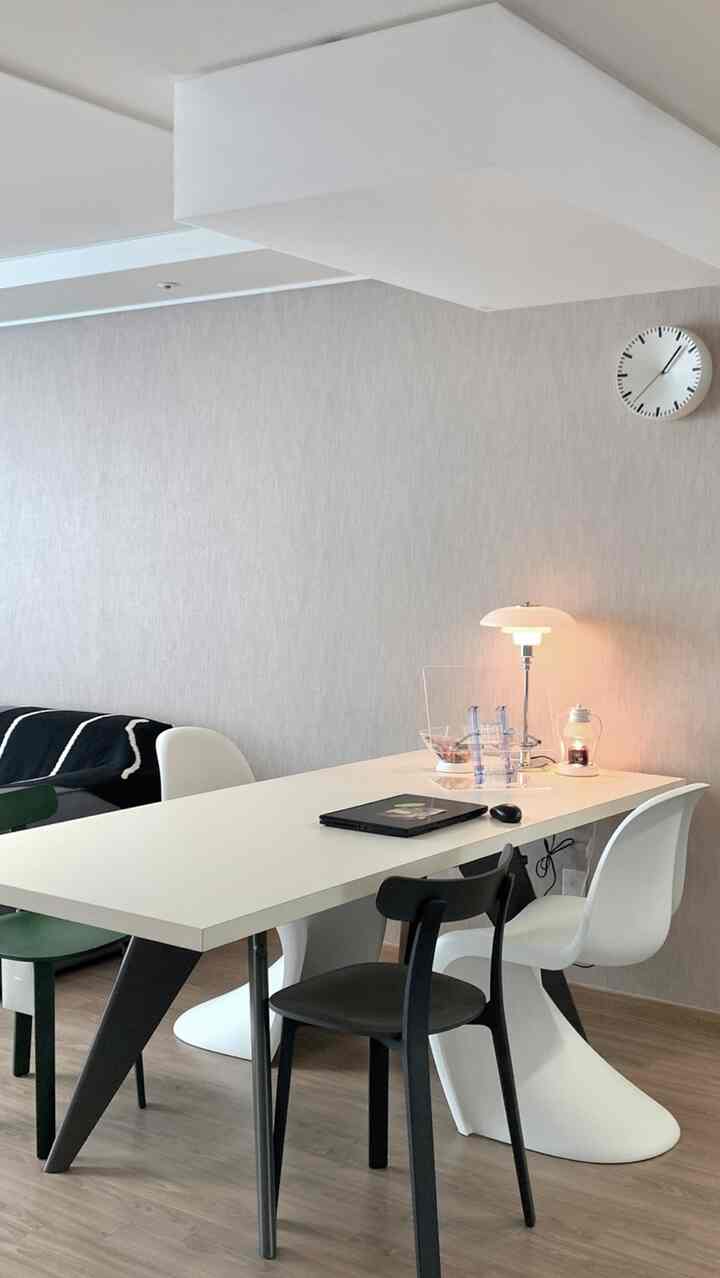 White and brown workspace and dining area featuring Vitra chairs and lamps in a simple modern room