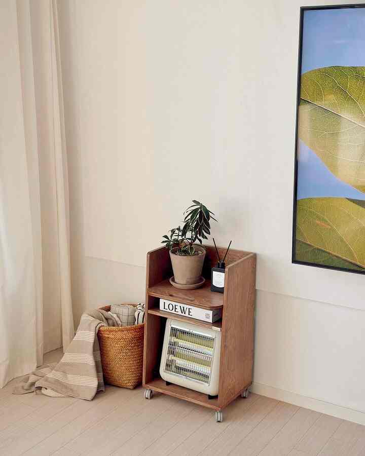 Natural wood tones and beige rattan basket in a corner of a living room, creating warm and cozy atmosphere