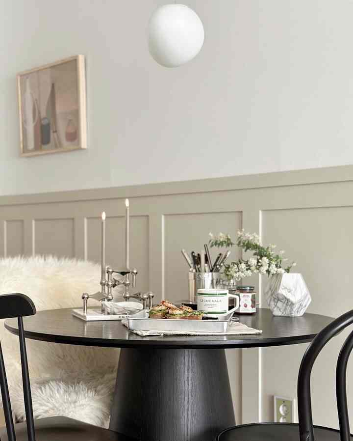 White and black toned dining room featuring a modern cafe style with plated open toast and coffee on dining table and chairs