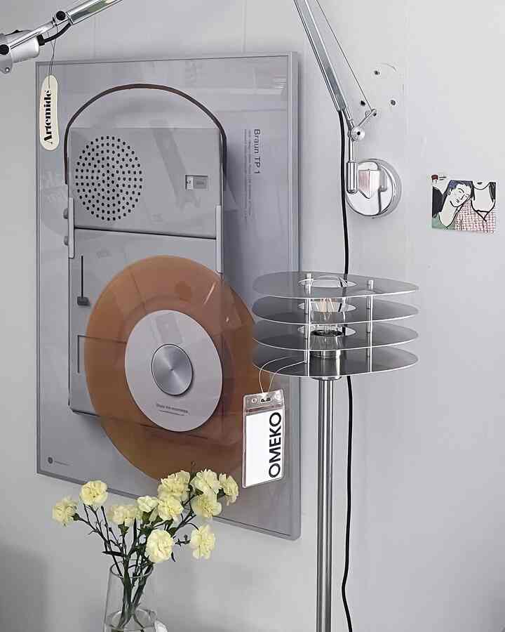 Silver-toned wall and floor lamp in a clean, modern interior space