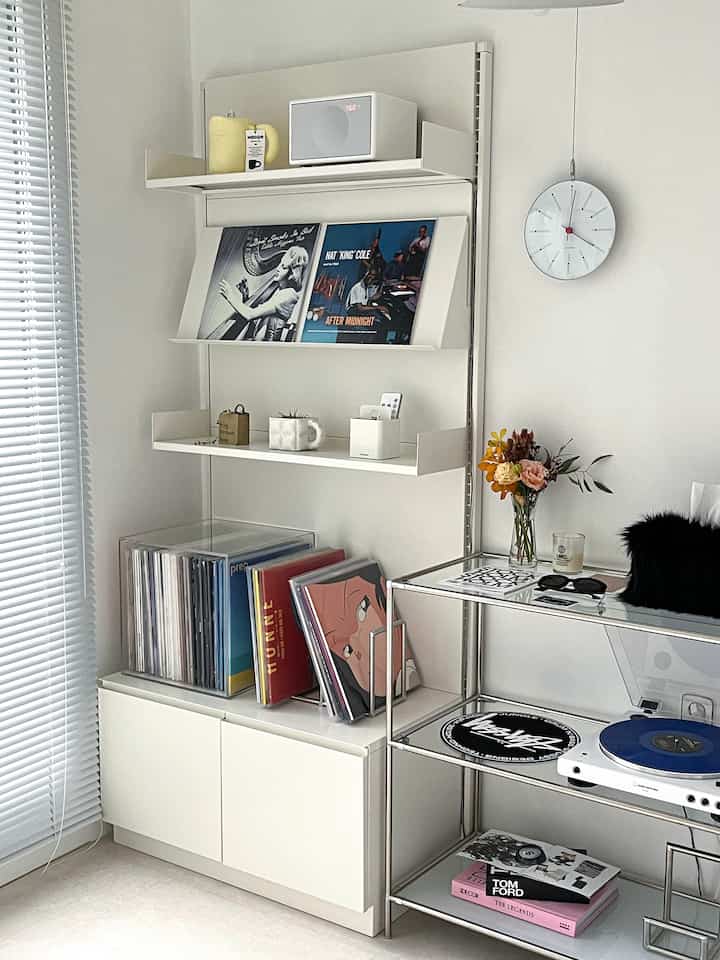 White-toned living room music listening area featuring shelves, turntable, and neat vinyl collection with minimalistic vibe.
