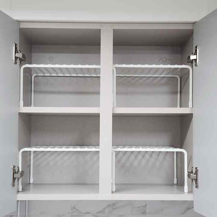 White-toned kitchen cabinet interior featuring adjustable shelves for organized storage