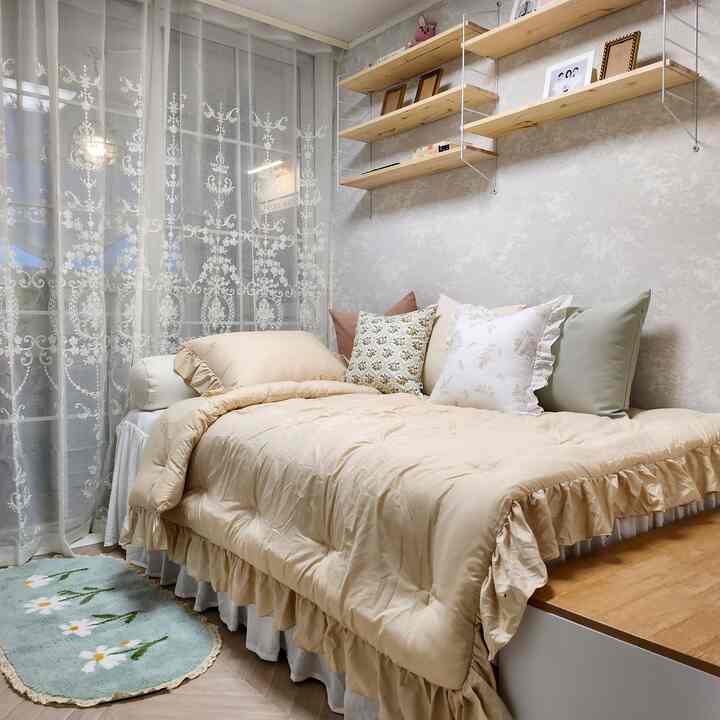 Natural beige and white bedroom featuring ruffled bedding and decorative pillows, creating a warm and elegant atmosphere