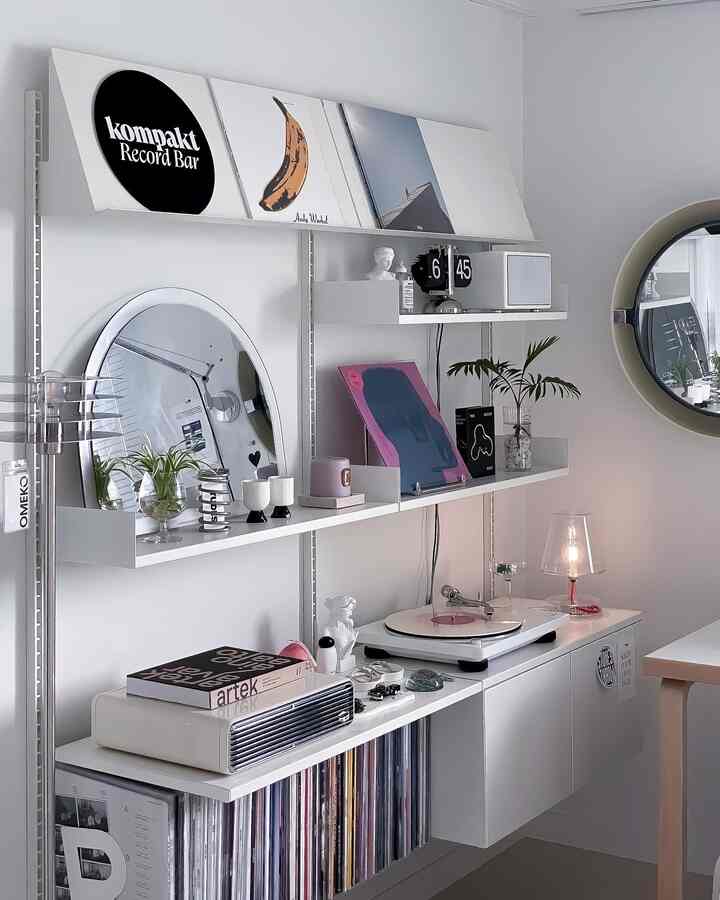 White-toned retro-inspired music zone living room featuring a turntable and vinyl records in a stylish setup