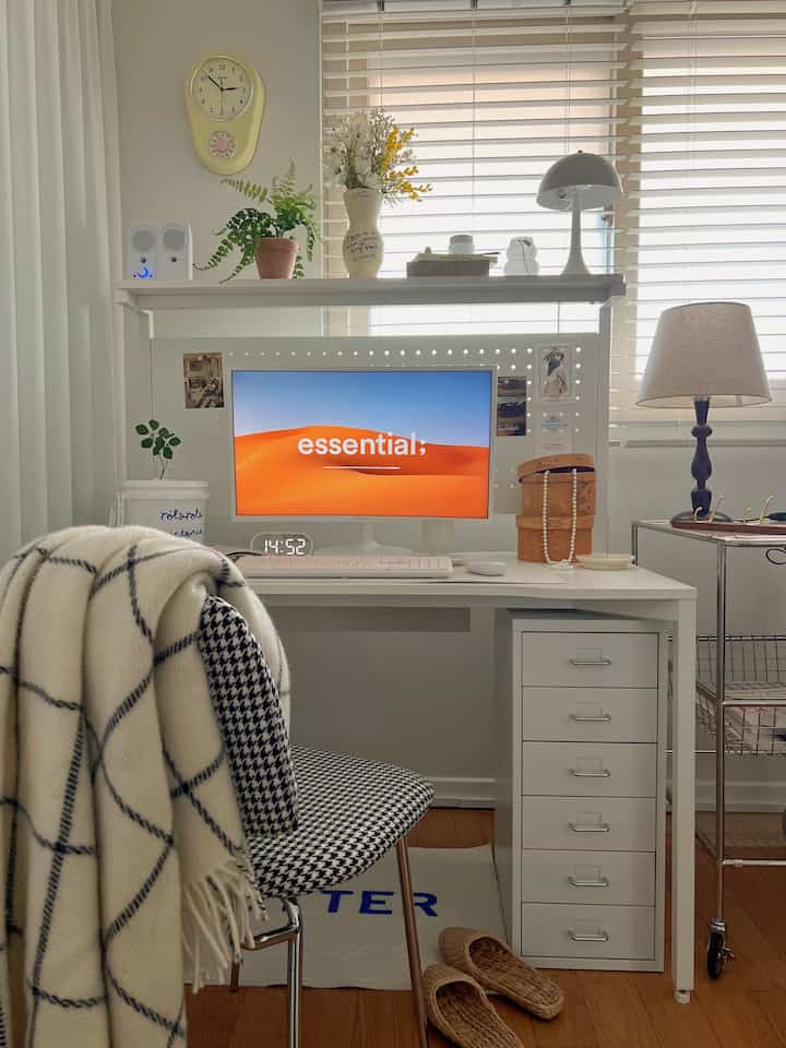 White and wood-toned home office space featuring a computer desk with shelves and drawers in a clean, minimal natural style