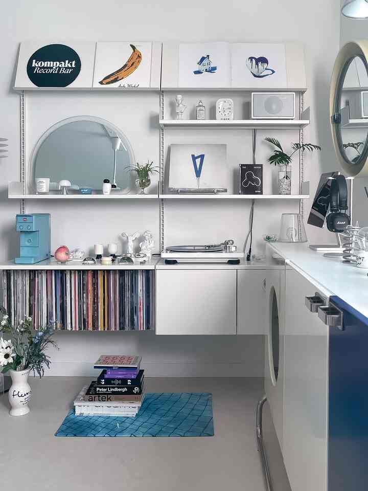 ホワイトとブルーのトーンのリビング、ミッドセンチュリーモダンスタイルのレアロウ棚とヴィンテージのLP収納、コーヒーマシンがある清潔感のある空間