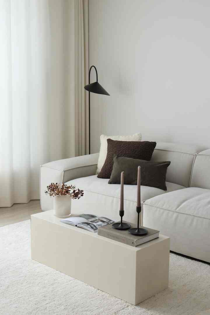 Ivory-toned living room featuring a DIY painted coffee table, cream sofa with cushions, creating a simple and natural atmosphere