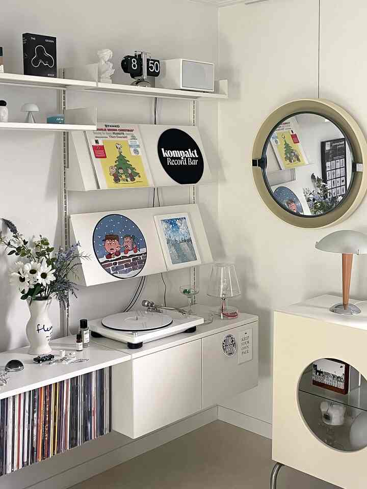 White and gray toned living room featuring vintage record shelf and turntable in mid-century modern style interior