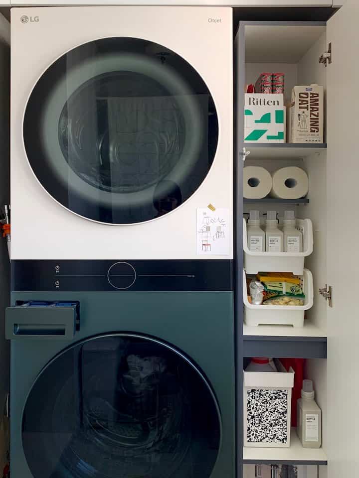 White and dark gray toned kitchen balcony storage space featuring LG WashTower and gap storage cabinet arranged efficiently with a clean and practical look
