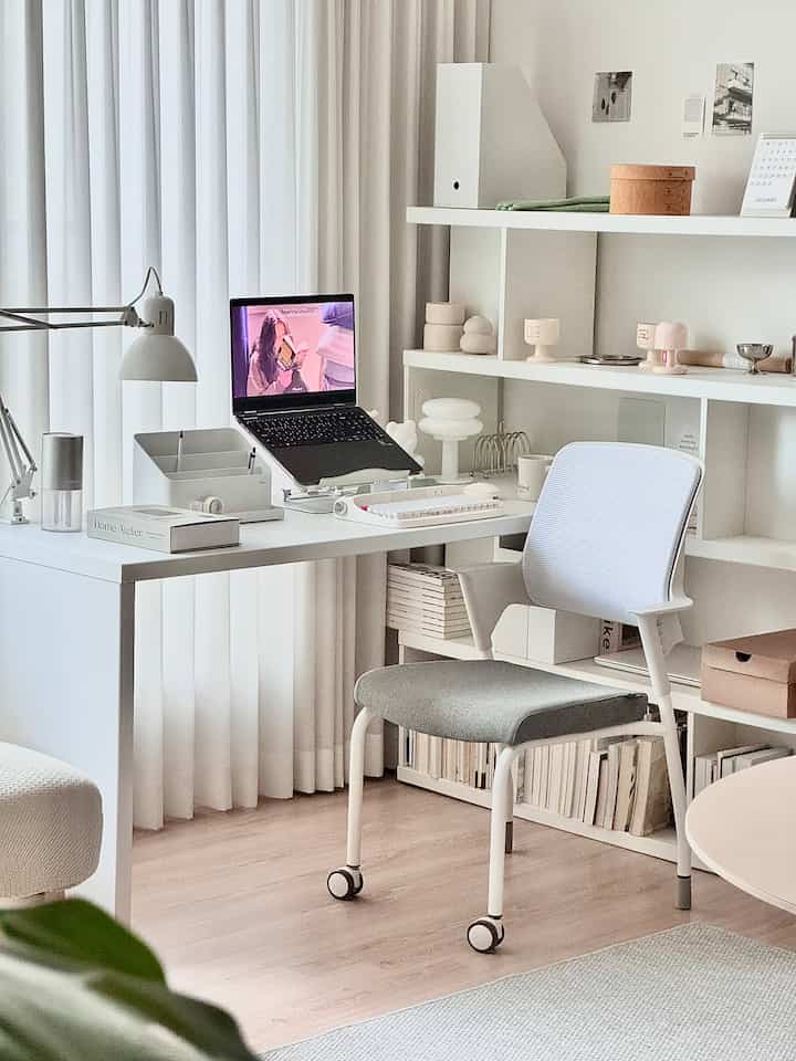 Monotone white and gray home office featuring a desk and office chair with a minimalistic vibe