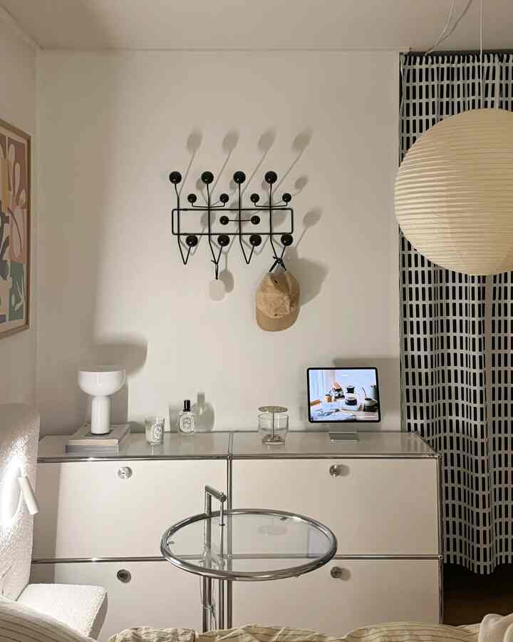 White and black toned room featuring a natural modern style side table and chest of drawers creating a neat home office space