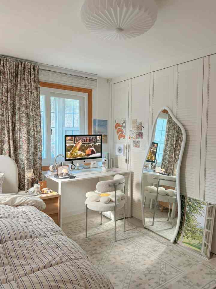 White and wood-toned small bedroom featuring a desk, window, and floor rug, creating a cozy atmosphere