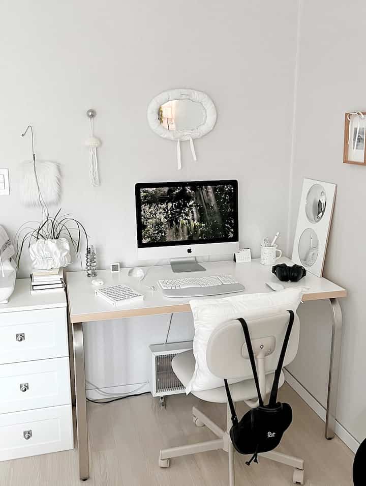 Bright white and natural tone home office featuring a clean desk with white desk and chair setup