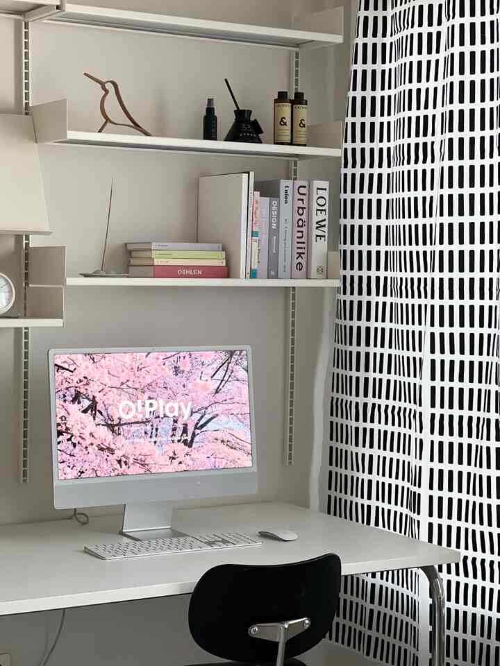 White and black toned study featuring iMac, shelves, and patterned curtain with a simple, clean workspace atmosphere
