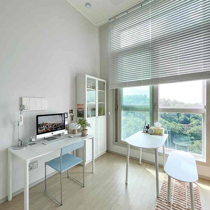 白とナチュラルトーンの明るく清潔なリビング、デスクと本棚が配置された雰囲気のあるホームオフィス