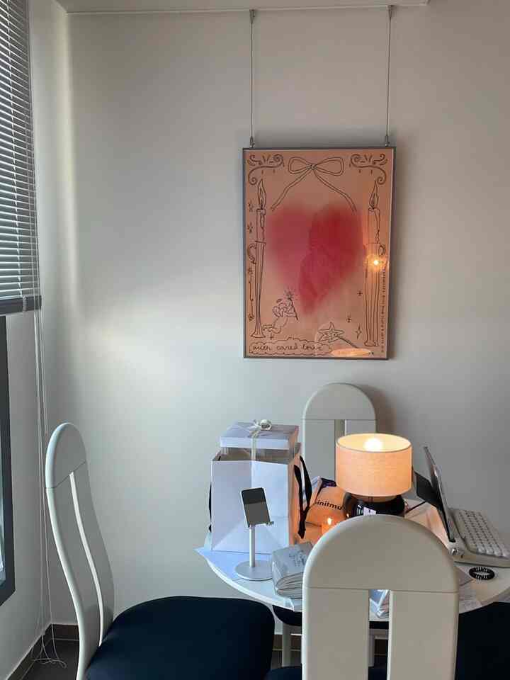 白と黒のトーンの4人用ダイニングテーブルと椅子が配置されたモダンな空間、テーブル上のランプとアルミブラインドが特徴的なインテリア