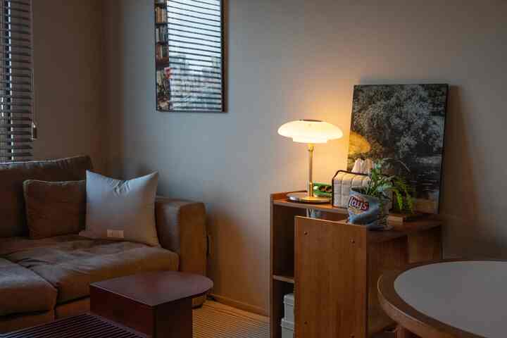 ブラウンとアイボリーの色調のリビングとダイニング空間、L字型の棚で区分し、居心地の良く実用的なインテリア