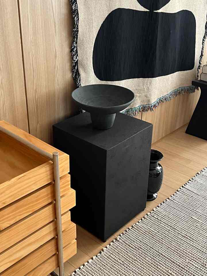 ナチュラルな木目調の床と黒のオブジェが配置されたクラシックで自然な雰囲気のインテリア