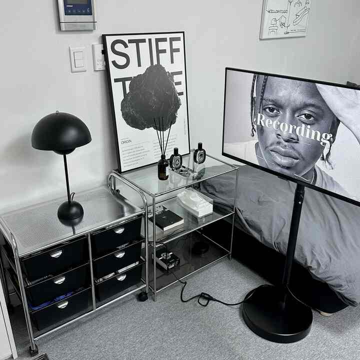 白と黒、グレーのトーンのコンパクトな寝室、メタル家具とシンプルなホームオフィスが調和したモダンな雰囲気のインテリア