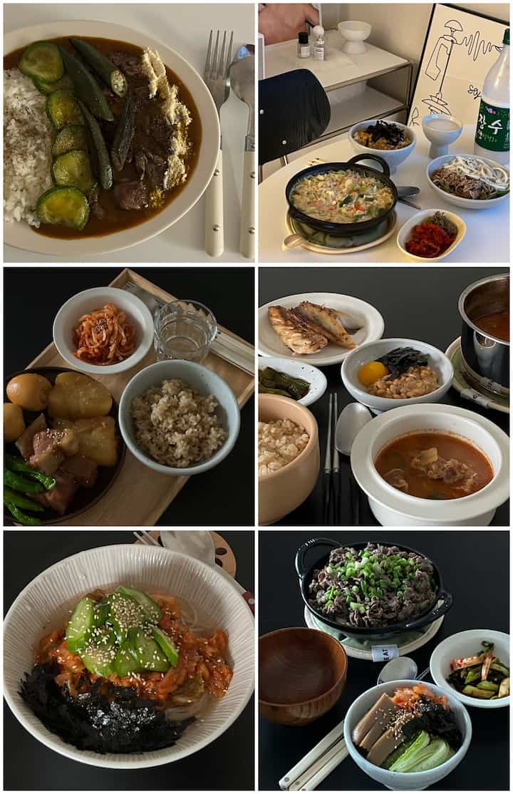 明るい白色と暗いトーンのテーブルに様々な韓国料理の器や鍋が配置された、雰囲気のある食事空間