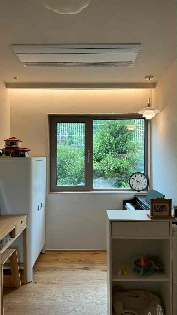 白と木目調が調和した子供部屋、赤ちゃんの衣装収納とおもちゃ収納が配置された雰囲気のある空間