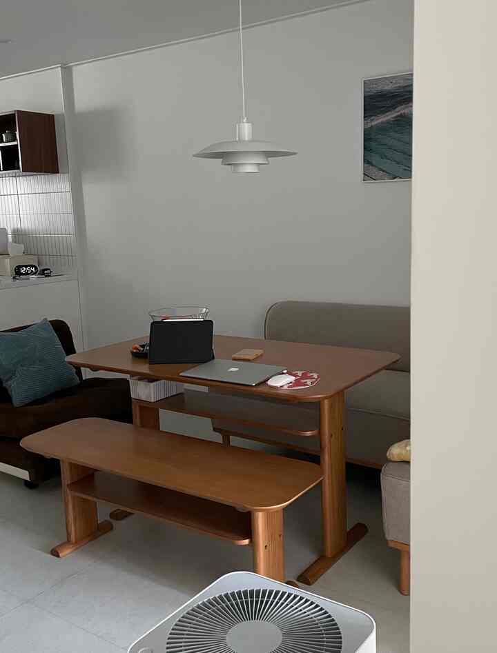 白い壁と木目調の家具が調和したダイニング、ソファとペンダントライトが配置された落ち着いたホームオフィス空間