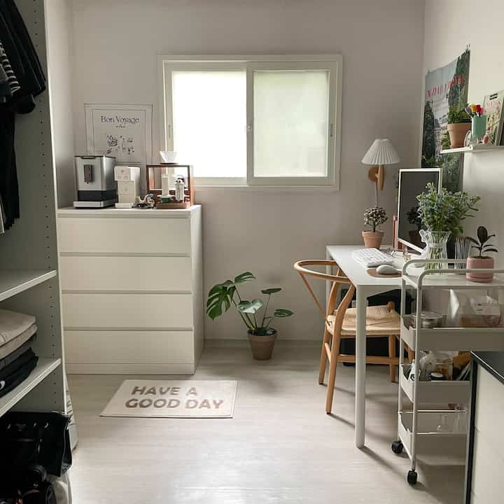 白と木目調の小さなマルチルーム、クローゼットと化粧台、ホームカフェスペースと作業スペースが配置された雰囲気のあるインテリア