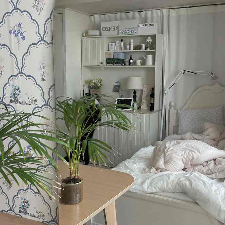 白とナチュラルカラーの寝室、ベッドと収納棚が配置された落ち着いた空間