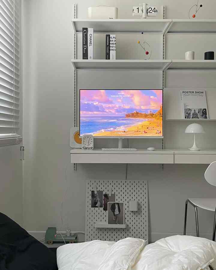 白を基調としたワンルームのホームオフィス、机とモニターが配置されたシンプルな空間