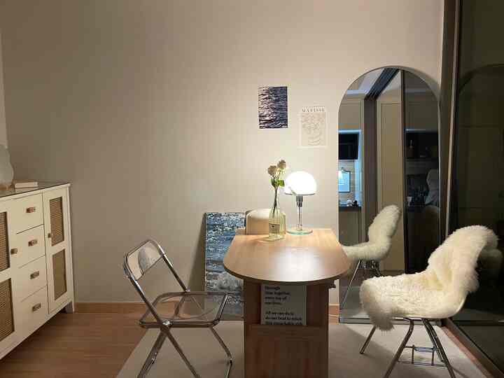 ホワイトとウッドトーンが調和したミッドセンチュリーモダンスタイルの一人暮らし用ダイニングスペース、アーチ型の全身鏡が配置された雰囲気のあるインテリア