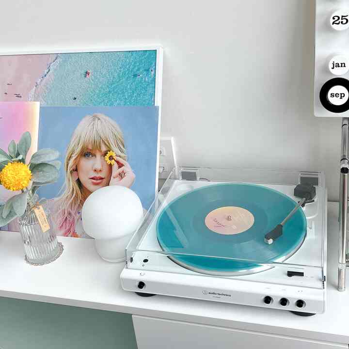 ホワイトとブルーの色調の清潔感のある空間、オーディオテクニカのターンテーブルと額縁が配置された雰囲気のあるインテリア