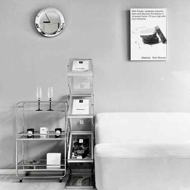 モノトーンのリビング、左側にシルバーのバーカートとマガジンラックが設置され、モダンな雰囲気を醸し出しているインテリア。