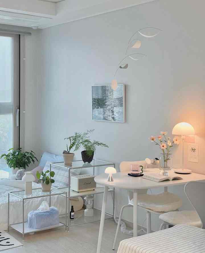 ホワイトとスカイブルーのトーンのワンルーム、ベッドとデスクが分かれて配置されたモダンで清潔感のある空間