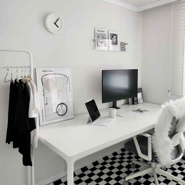 白を基調としたホームオフィス、広いデスクとモニター、事務用チェアが整然と配置された現代的で実用的な空間