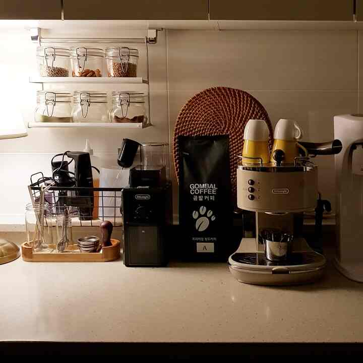 Warm ivory-toned kitchen home cafe featuring DeLonghi coffee machine and rattan placemat, creating a cozy atmosphere
