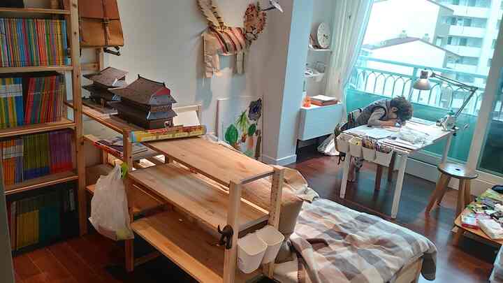 白と木目調が調和する子供部屋、書棚とデスク、ベッドが配置された学習と休息に適した空間