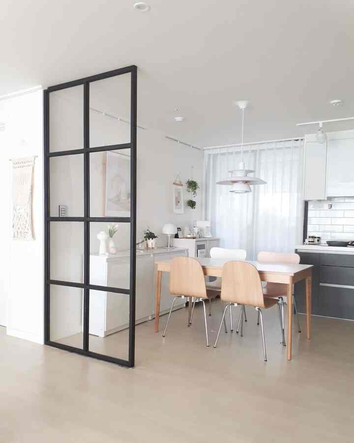 Bright white and wood tone kitchen and dining room featuring natural and modern elements in a cozy atmosphere