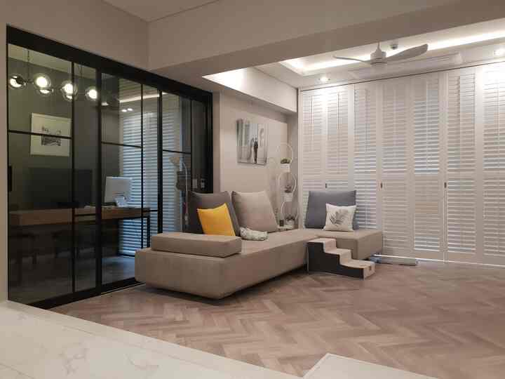 Cozy living room with white shutters and natural tone sofa