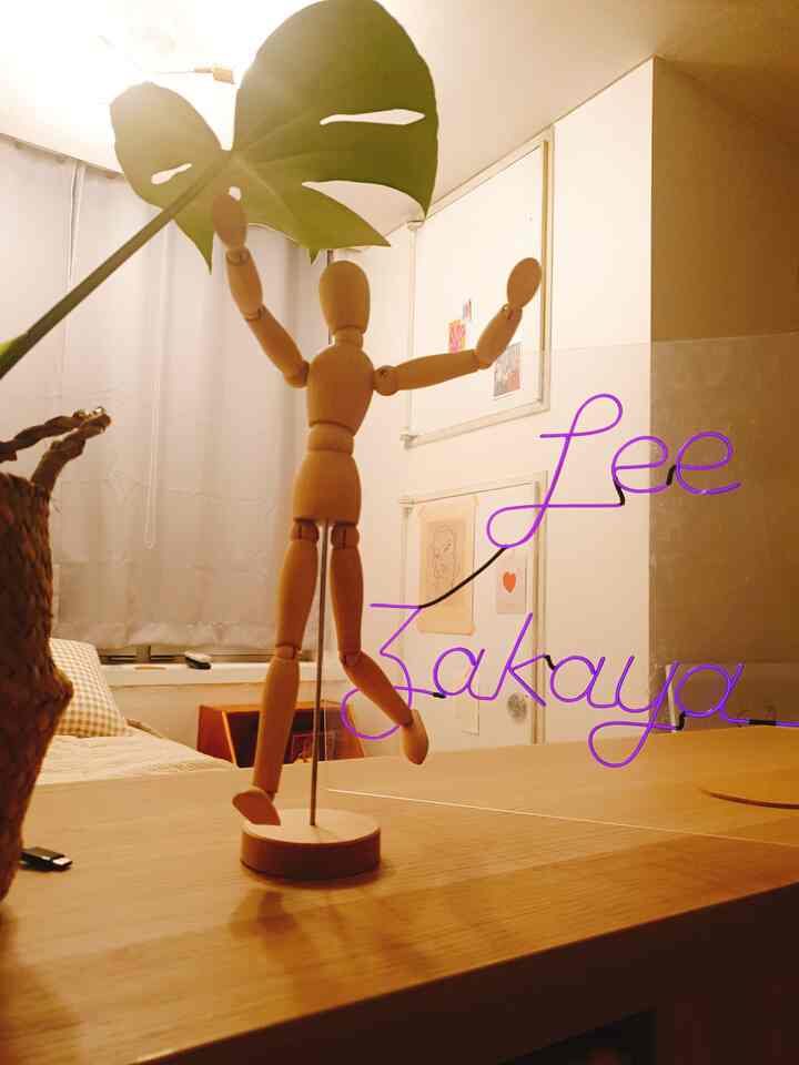 A wood-toned natural living room featuring a wooden mannequin and purple neon sign creating a cozy ambiance